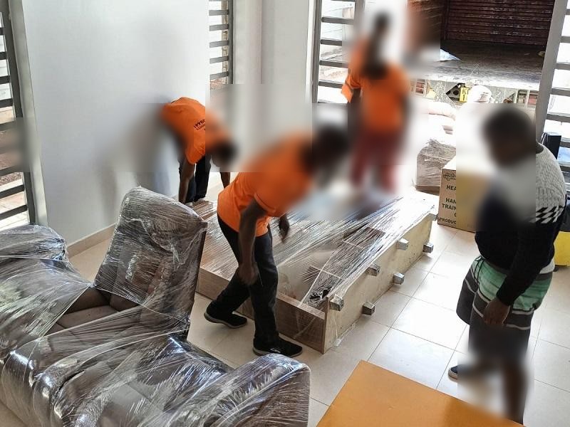 Movers in Nairobi wrapping furniture for a house move